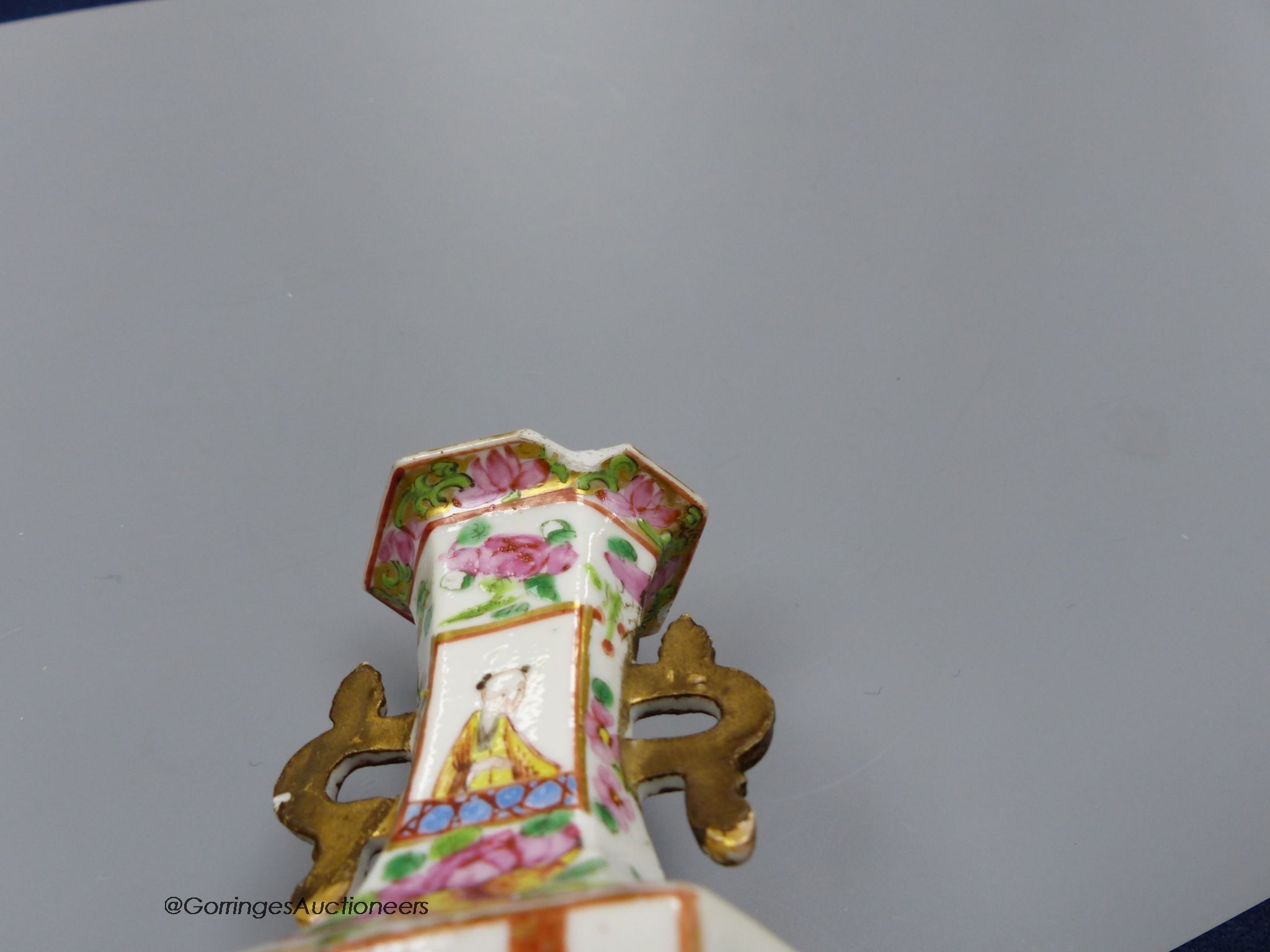 A Chinese famille rose small vase and two cups and saucers